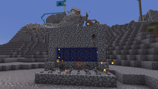 A cobblestone computer in minecraft on fire.